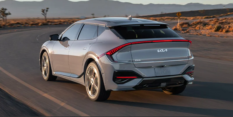 A photo of a grey 2025 Kia EV6 driving down the road.